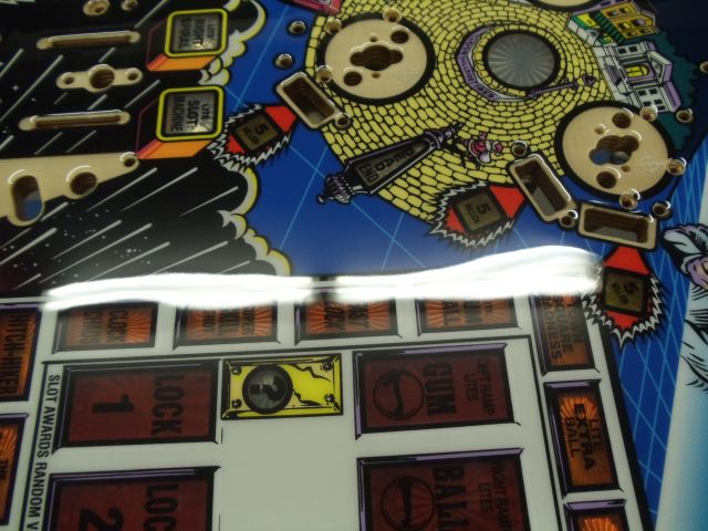 13
The next  few pics will be used to show the thickness and wavy nature of this playfield through overhead light reflections.N