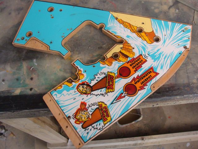 59
 Mylar removed and  the playfield is cleaned.There is some graining showing in the  blue and white areas.Once cleared I will