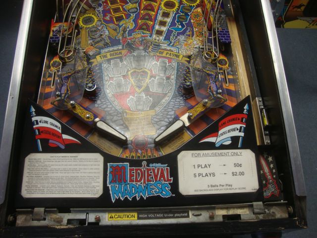 4
 Playfield is well worn and  has some  screws popping up through it here and there.